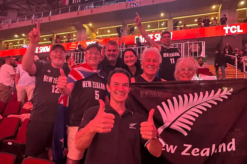 Fans cheering and giving thumbs up in the stands at the 2023 FIBA World Cup in Manila